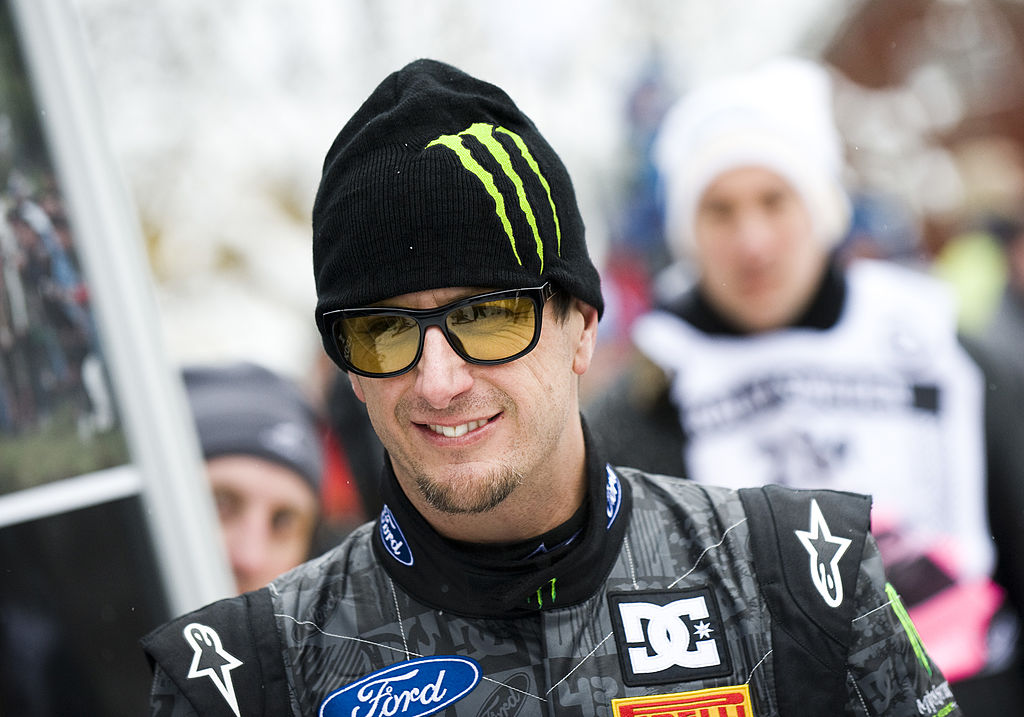 U.S. Rally Car driver Ken Block wearing a racing jacked, sunglasses and a Monster branded wool knit cap