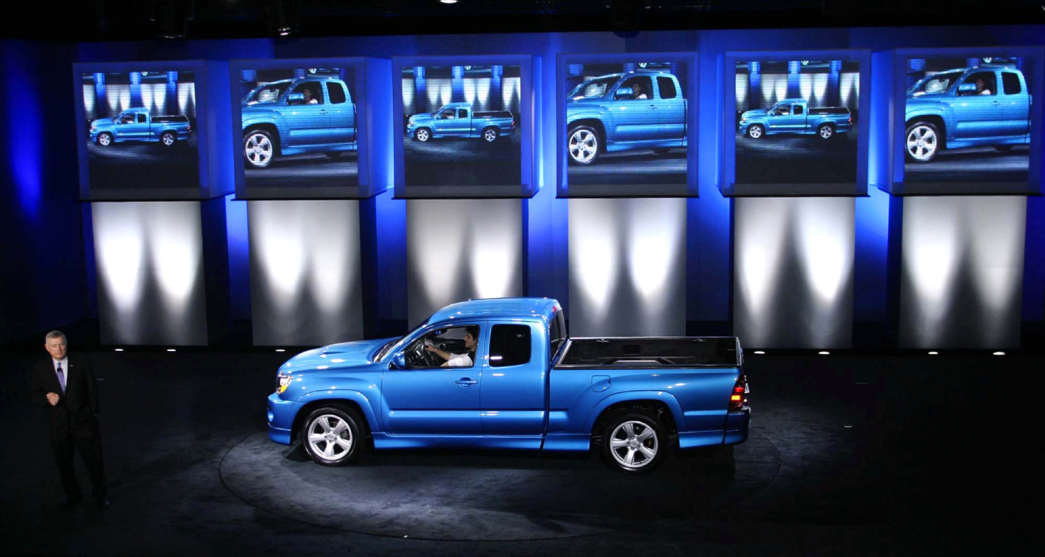 A blue Toyota Tacoma X-Runner on display at a show