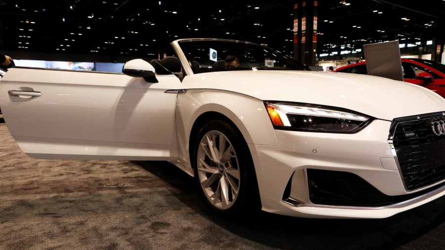 A white Audi A5 on display at an auto show