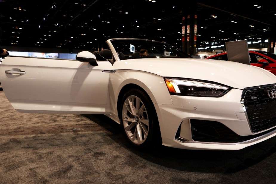 A white Audi A5 on display at an auto show