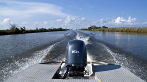 A Yamaha engine propels a boat near marshlands on the Harry Bourg Corp. preserve in Louisiana, U.S.