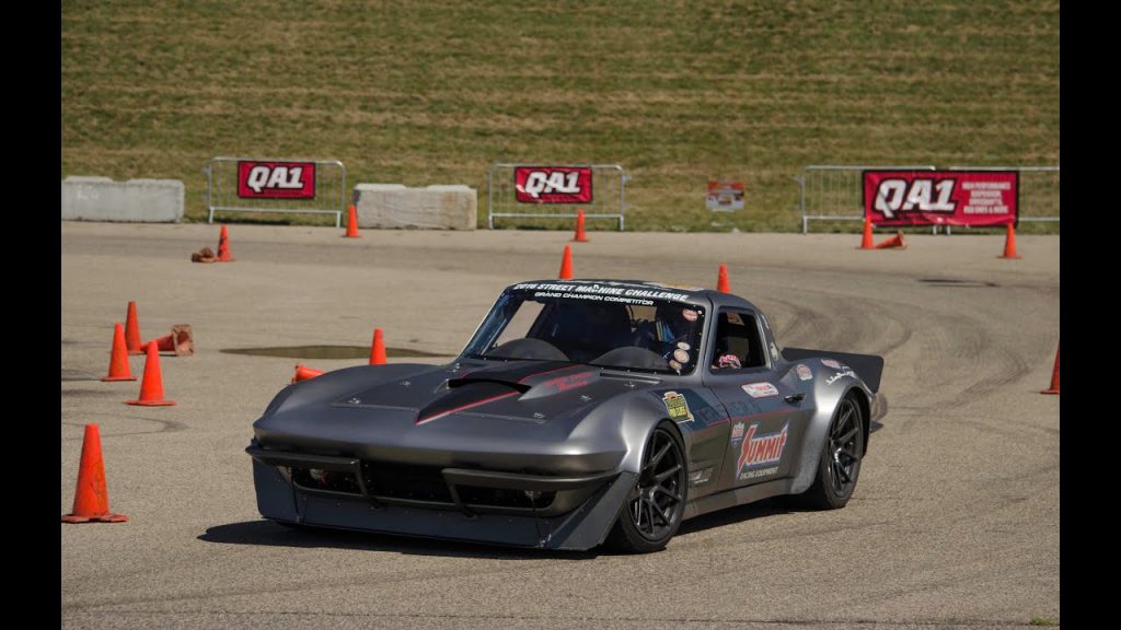 A modified car races on an autocross course