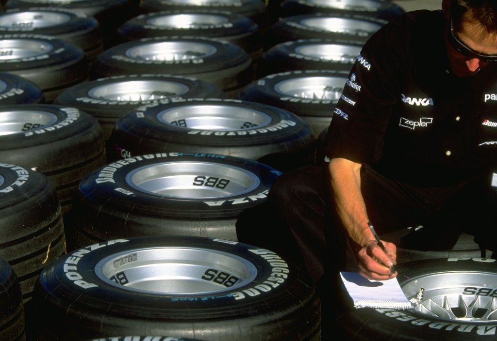 An Arrows mechanic checks the Bridgestone tires before the Australian Grand Prix at Albert Park.
