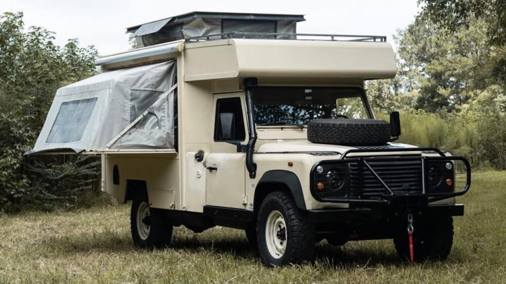 1990 Land Rover Defender 130 dream RV camper-truck conversion parked in a field 
