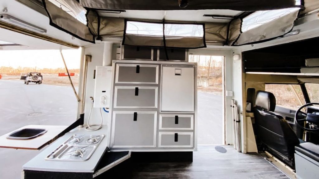 rear hatch of a 1990 Land Rover Defender camper opened up