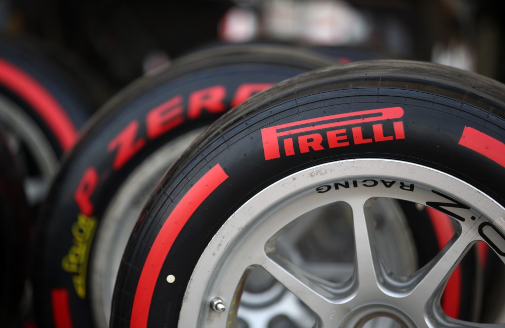 A partial close-up view of three racing tires with the red Pirelli logo on them