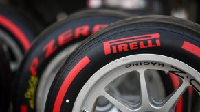 A partial close-up view of three racing tires with the red Pirelli logo on them