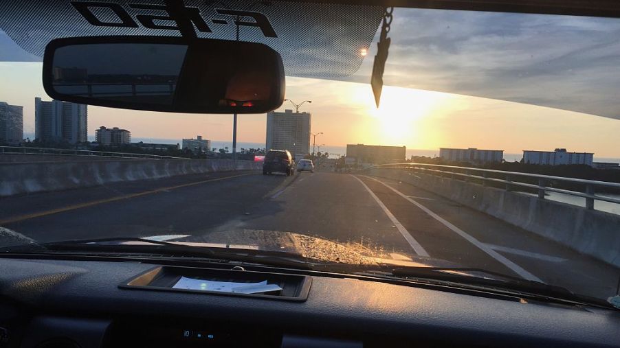 Overlooking a ford f-150 dash while going over a bridge at sunrise