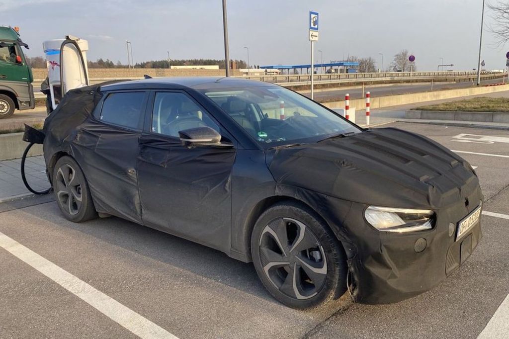 shrouded Kia "CV" that has yet to be released is siad to rival the Porsche Taycan
