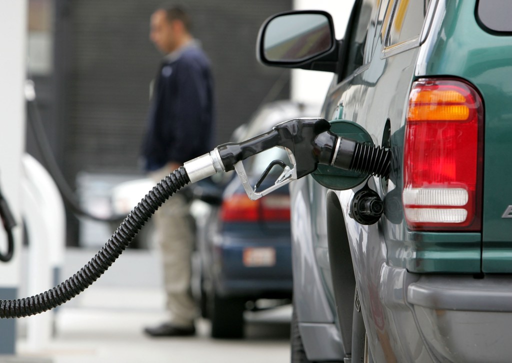  A gas pump pumps fuel into a car at a Shell service station. 