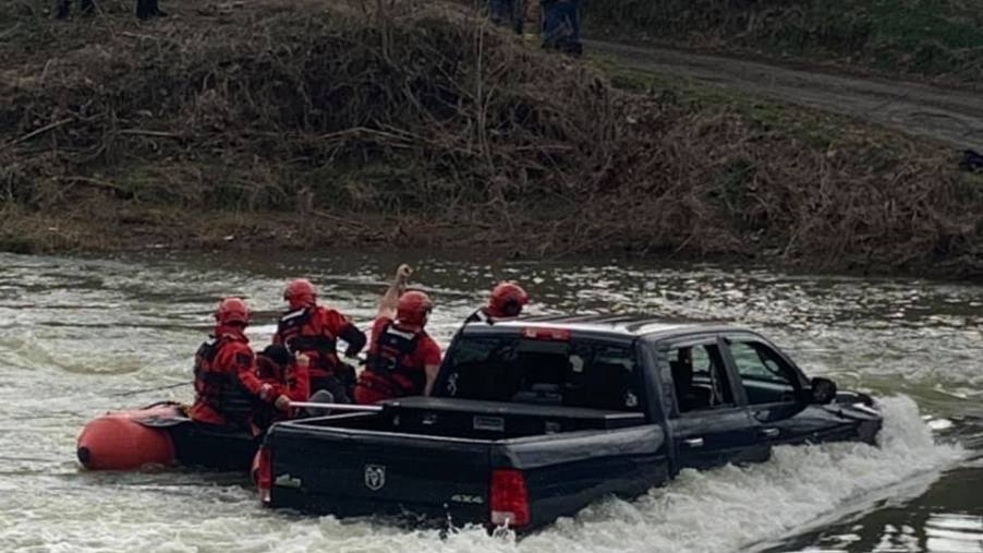 Family being rescued from Ram 1500 Classic in floodwater