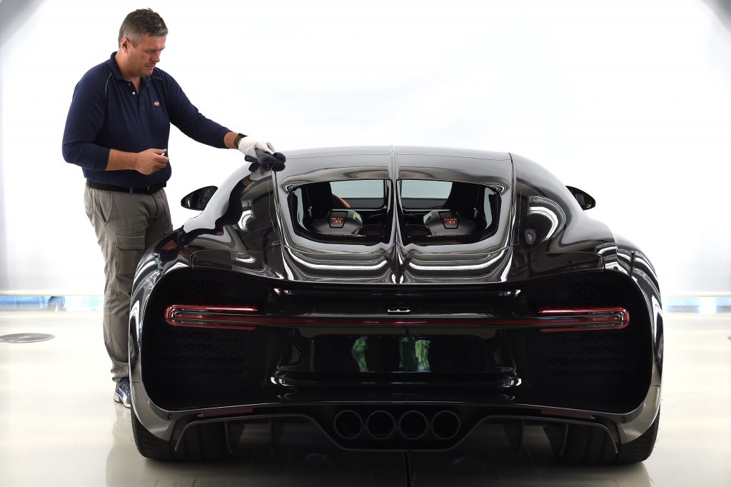 An employee cleans a car at the luxury automobiles manufacturer Bugatti's headquarters.