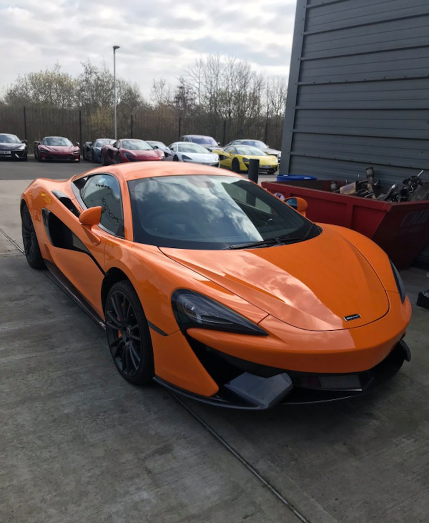Stolen McLaren in orange sitting in a parking lot
