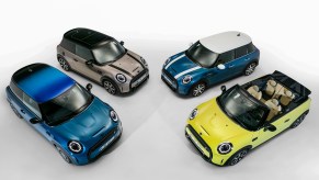 An overhead shot of four models of Mini Cooper