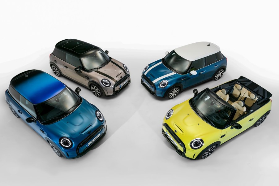 An overhead shot of four models of Mini Cooper