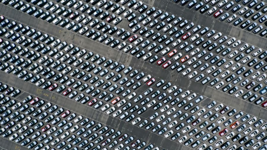 An areal view of a large parking lot filled with Subarus