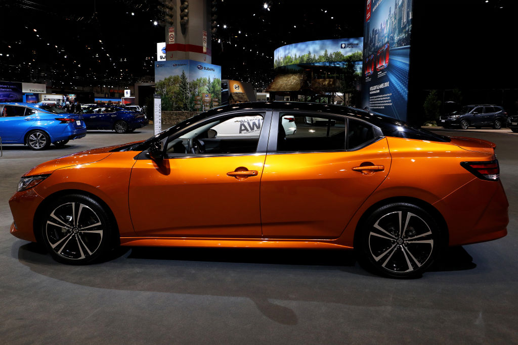 An orange 2020 Nissan Sentra on display from the side