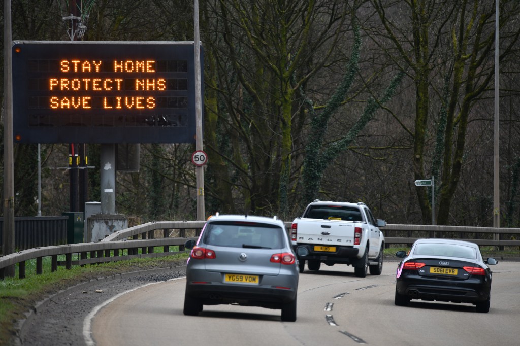 Cars drive past a sign on the A82 north bound in Glasgow, Scotland. 
