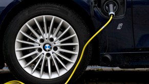 A plug-in hybrid BMW car with an electricity charger