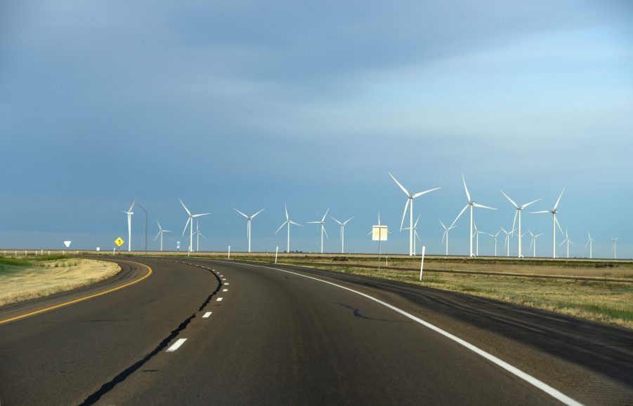 Wind turbines, like the one that powers the Wind Explorer, line a rural highway in Texas