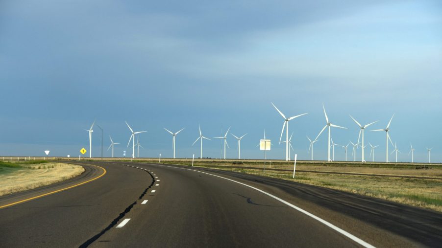 Wind turbines, like the one that powers the Wind Explorer, line a rural highway in Texas