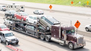 A trailer truck transporting cars being shipped.