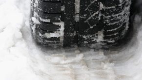 A close up of a tire in the snow