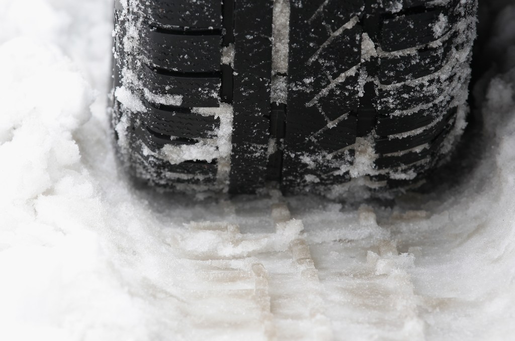A car tire in the snow. |