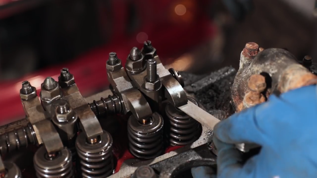 A valve adjustment being performed on a cylinder head 