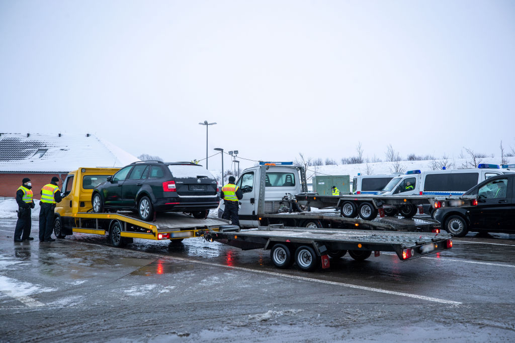 Vehicles being loaded onto a towing vehicle