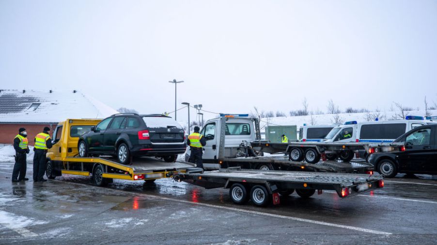 Vehicles being loaded onto tow trucks