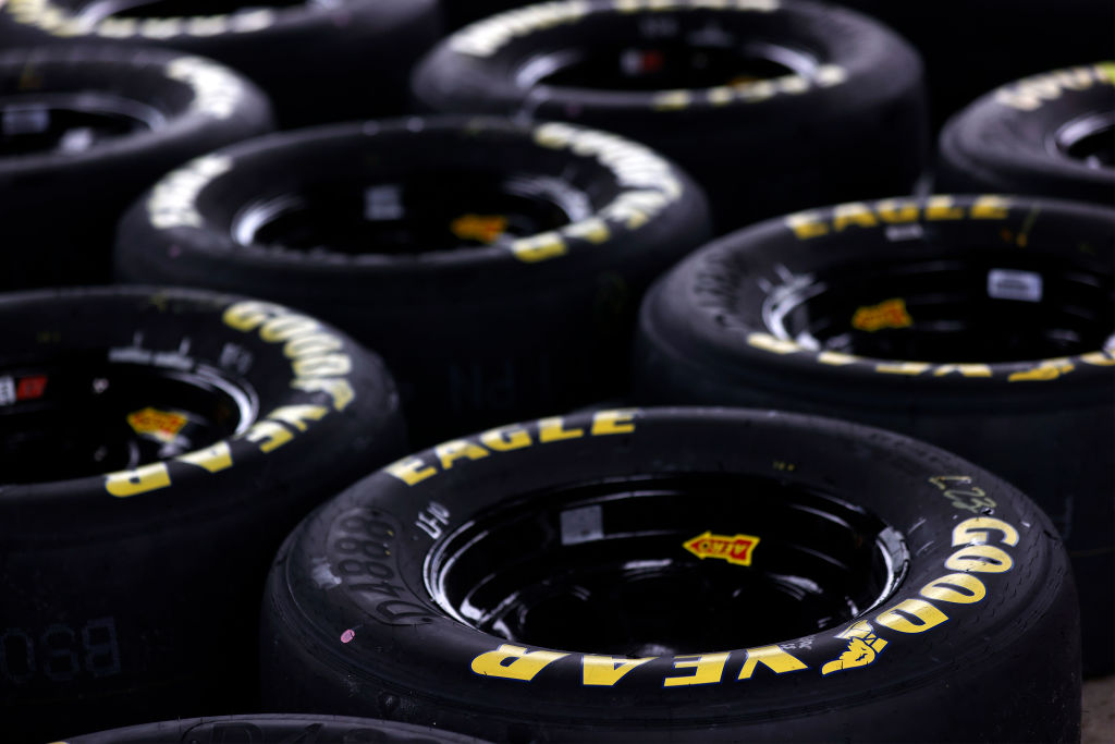 A bunch of GoodYear tires laying together not in use