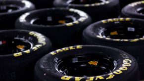 A bunch of GoodYear tires laying together not in use