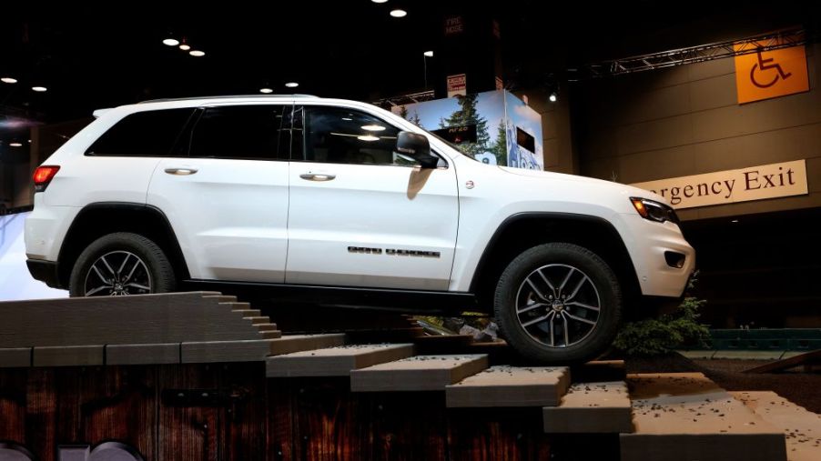 A white Jeep Grand Cherokee SUV on dispaly