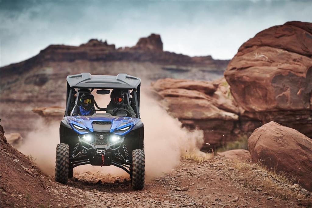 a Yamaha wolverine side-by-side UTV in the desert navigating red and rocky terrain