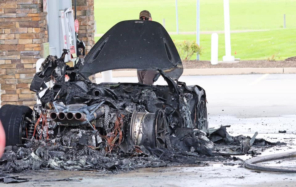 An image of a McLaren 765 LT on fire at a gas station.
