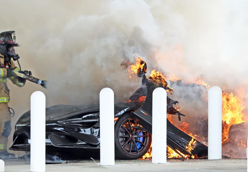 An image of a McLaren 765 LT on fire at a gas station.