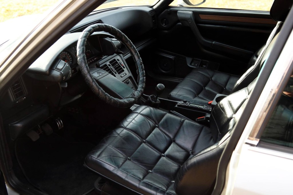 The black-leather-upholstered front seats and dashboard of a 1986 Citroen CX 25 Prestige Turbo