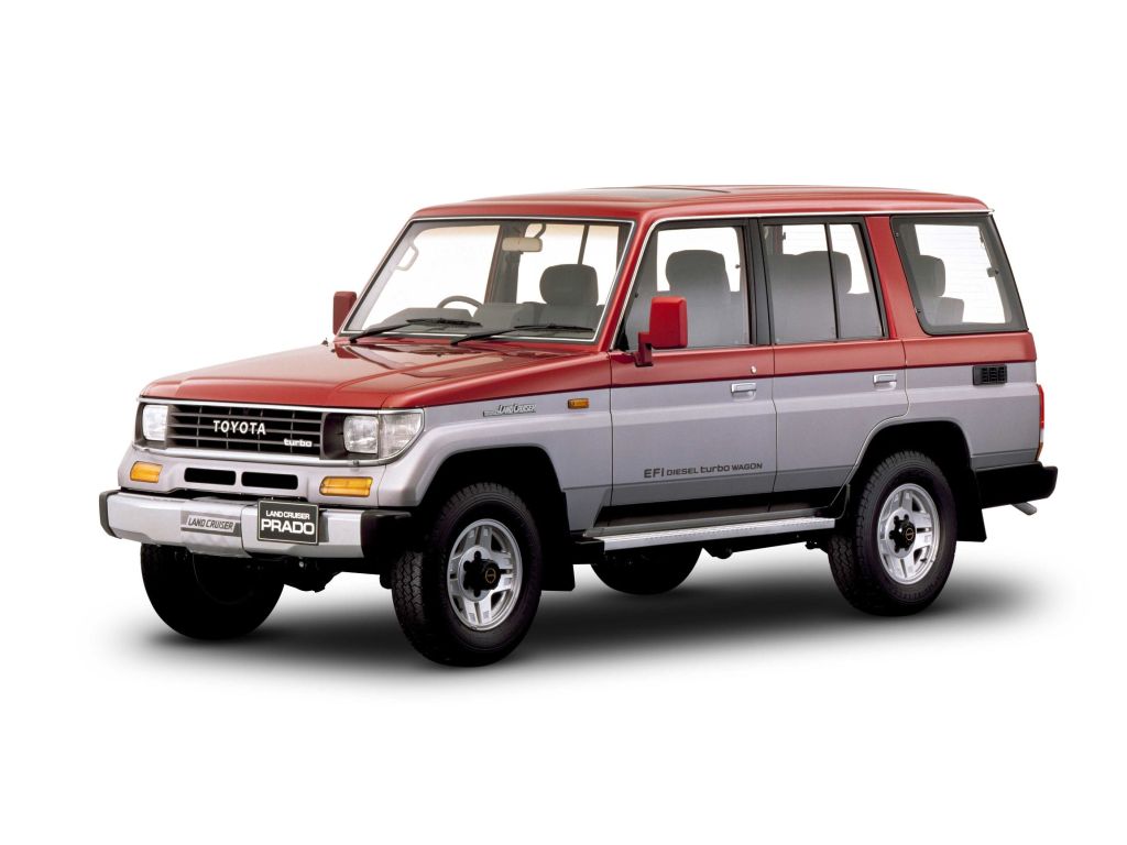 A red-and-gray 1990 Toyota Land Cruiser Prado