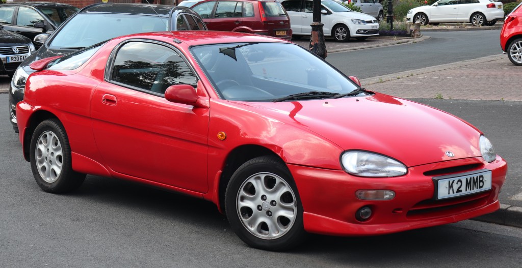 a red 1992 Mazda MX-3 shown from the front