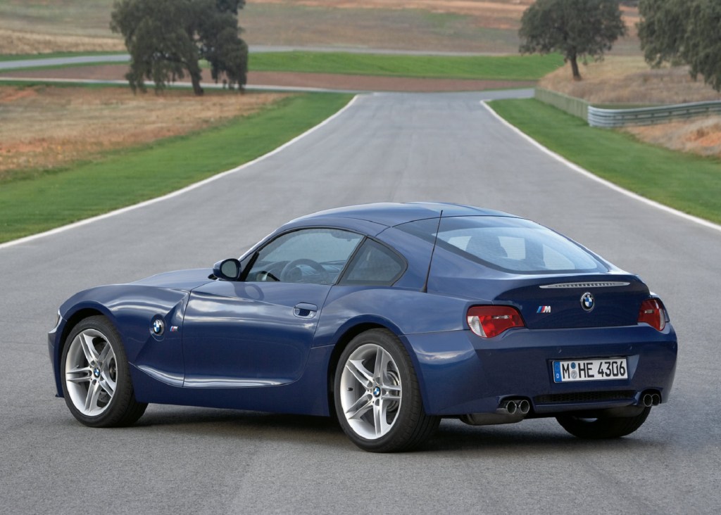 The rear 3/4 view of a blue 2006 BMW Z4 M Coupe on a racetrack