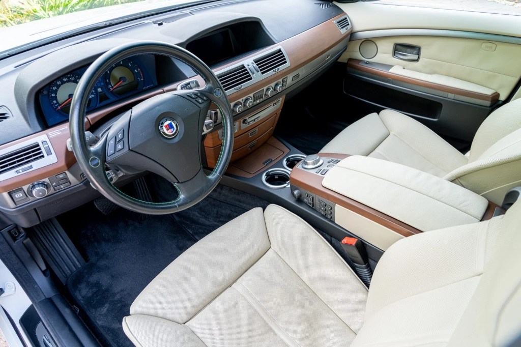 The white-leather-upholstered front seats and brown-wood-trimmed dash of a 2007 BMW Alpina B7