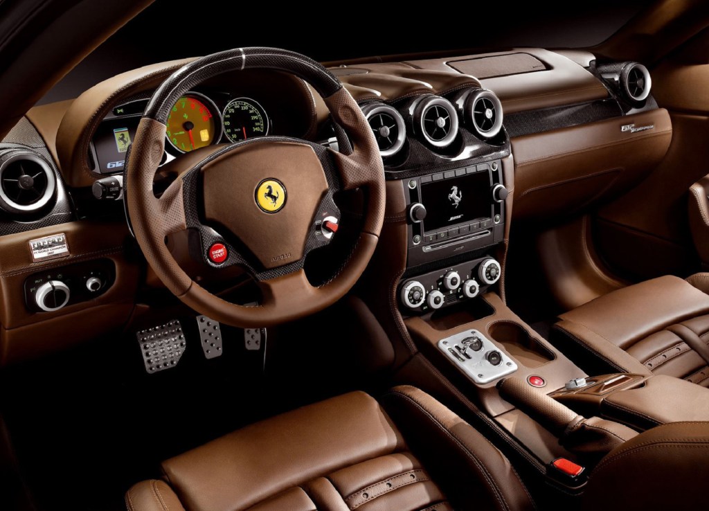 The brown-leather-and-carbon-fiber front interior of a 2009 Ferrari 612 Scaglietti