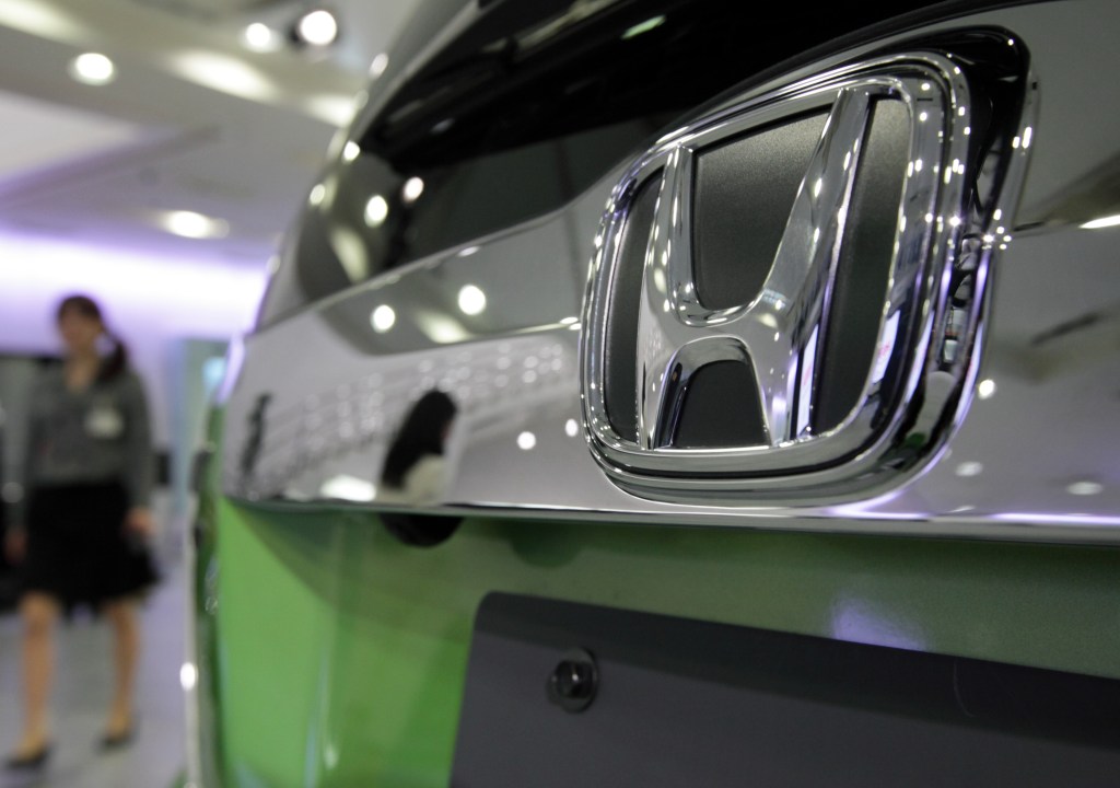 A closeup of the bumper of a green 2012 Honda Fit, one of the best used cars