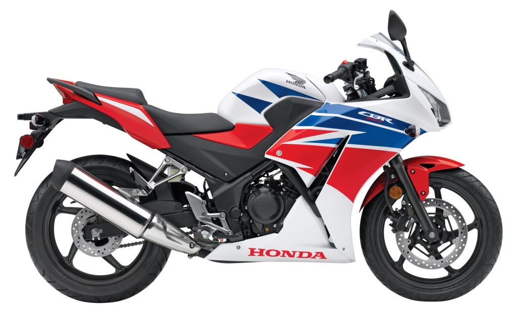 The side view of a white-red-and-blue 2015 Honda CBR300R