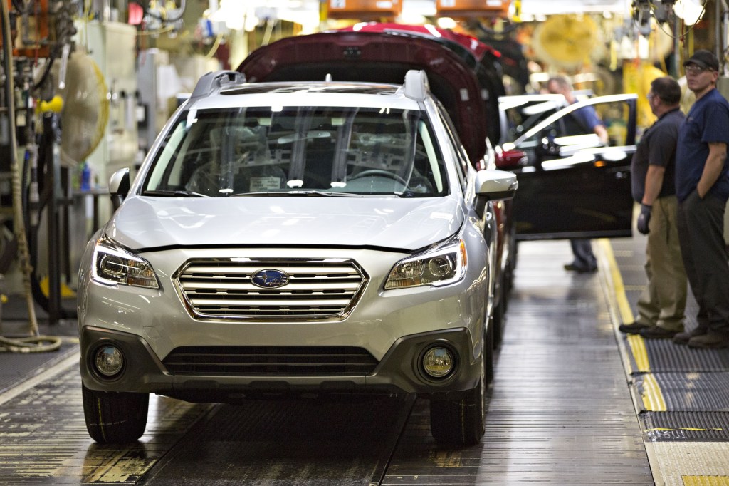 A silver 2016 Subaru Outback SUV on the assembly line