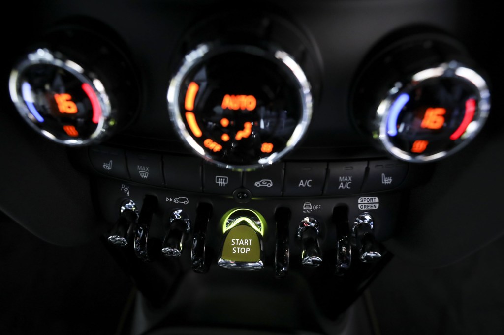 A close-up of the 2020 Mini Cooper SE's dashboard focusing on the push-button start ignition switch