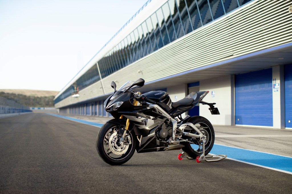 A black-and-silver 2020 Triumph Daytona 765 Moto2 Limited Edition on a rear-wheel stand on a racetrack