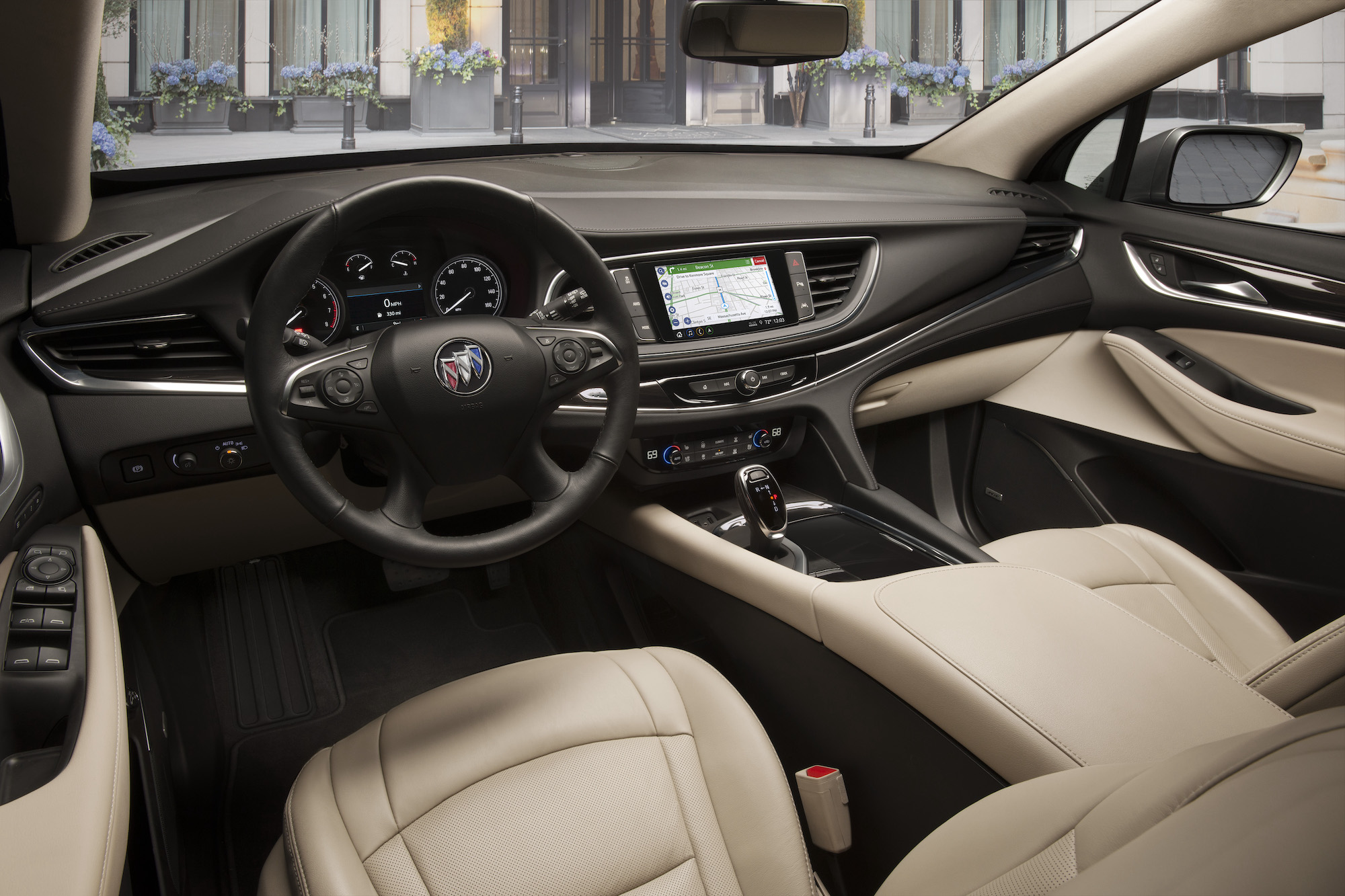 The beige and black interior of a 2021 Buick Enclave luxury midsize SUV