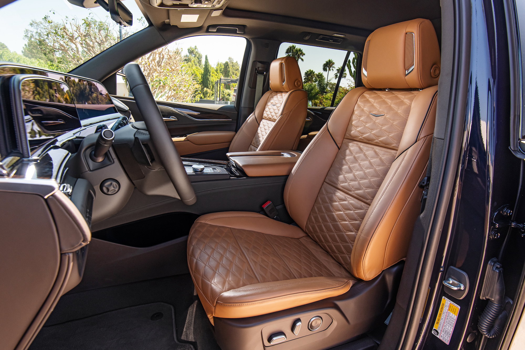 A 2021 Cadillac Escalade Brandy interior with Very Dark Atmosphere accents and full leather seats with faceted quilting